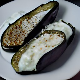 a dish with garlic-yogurt spread over halved roasted eggplants, spiced butter drizzled on top, and coriander and sesame seeds scattered on top.