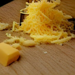 after chopping the cheddar cheese into small chunks, you will have 7 oz of chopped cheddar cheese. after shredding the 18 oz of cheddar cheese using a grater, you will have 18 oz of shredded cheddar cheese. after