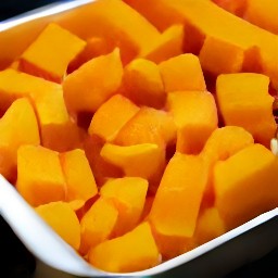 a roasted butternut squash dish with red chili peppers and olive oil.