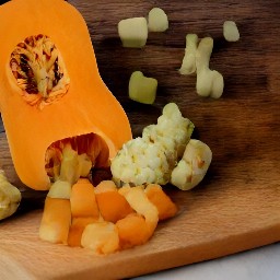 the butternut squash is cut into cubes and the cauliflower is cut into small florets.