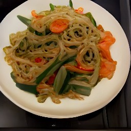 a stir fry with rice noodles, ginger, garlic, red bell pepper, carrots, zucchini, chestnuts and soy-orange sauce.