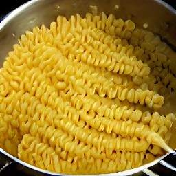 a pot of boiling water with fusilli pasta cooked in it.