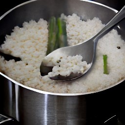 a pot of boiled rice with asparagus.