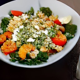 a bowl of roasted quinoa and vegetables mixed with garlic, olive oil, salt, black pepper, lemon juice, zest and feta cheese.