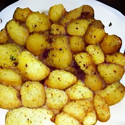 the spiced potatoes are transferred to a plate and lime juice is drizzled over it.