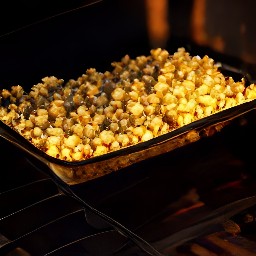 a popcorn mix that has been cooked in a roasting pan for 20 minutes, stirred, and returned to the oven for another 20 minutes.