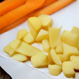potatoes and carrots that are rinsed and drained on a tea towel.