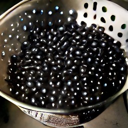 a colander full of rinsed and drained black beans.