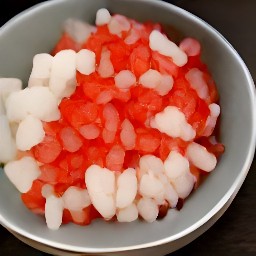 a bowl of mashed onions with chopped tomatoes.