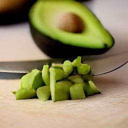an avocado that has had its stone removed and been peeled with a spoon, then chopped into small pieces.