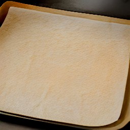 a baking sheet with a layer of baking parchment on top.
