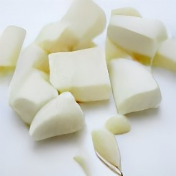 feta cheese that is cut and peeled garlic.