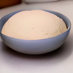 a bowl of focaccia dough that has been sprayed with cooking spray and covered with a clean towel. after 30 minutes, the towel removed from the bowl.