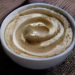a bowl of tahini and garlic paste mixed together.