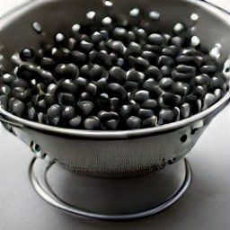 the black beans are drained and rinsed in a colander.