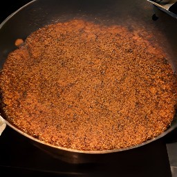 the chorizo is heated in a pan and cooked for 3 minutes before being stirred with a fork. it is then cooked for 4 more minutes before the heat is turned off.