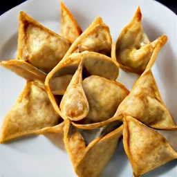 the jalapeno wonton puffs are transferred to a plate.