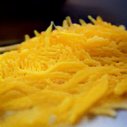 the output is monterey jack cheese that has been shredded with a grater.