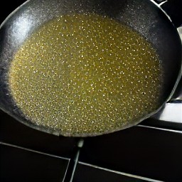the vegetable oil heats up in the skillet pan over medium temperature.