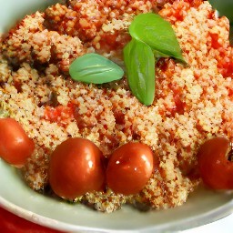 the tomatoes mixture is transferred to the pan without the lid and is mixed using a spoon.