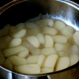 the cooked apples are divided into containers, covered with lids, and set aside for 90 minutes to rest. the containers are then put in the freezer for 15 minutes to chill.