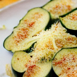 the grated parmesan cheese is on top of the baked zucchini.
