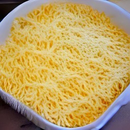 the contents of the large pan are transferred to an ovenproof dish. the breadcrumbs and the rest of the grated cheddar cheese are scattered on top. the ovenproof dish is placed in the hot oven and baked for 20 minutes