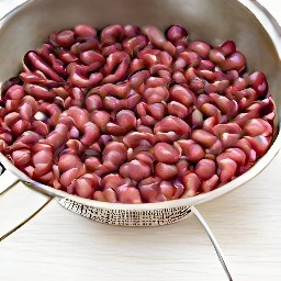 a sieve full of rinsed and drained kidney beans.