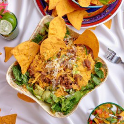 

Taco salad is a nutritious, gluten-free, egg-free, nut-free and soy-free no cook side dish made with kidney beans, green chili peppers, tomatoes endive leaves and topped with sour cream tortilla chips and cheddar cheese.