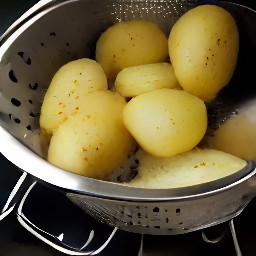 the cooked potatoes are drained in a colander.