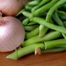 peeled and chopped onions and trimmed green beans.