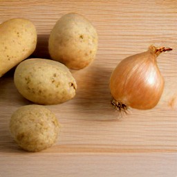 a peeled and chopped onion, and cut potatoes into 1/2-inch cubes.