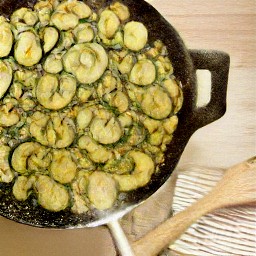 a plate of stir-fried portabella mushrooms, onions, garlic, and zucchini chunks seasoned with salt, black pepper, and oregano.