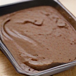 a brownie with cheese spread on top.
