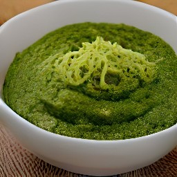 a bowl of pesto with lemon zest, grated parmesan cheese, salt, and black pepper.