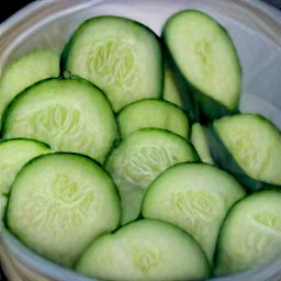 a bowl of cucumbers in cider vinegar.
