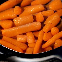 a dish of cooked carrots.