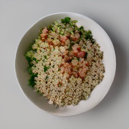 a bowl of quinoa salad with tomatoes, cucumbers, scallions, red bell pepper, lentils, and mung beans. the salad is topped with parsley and drizzled with vina