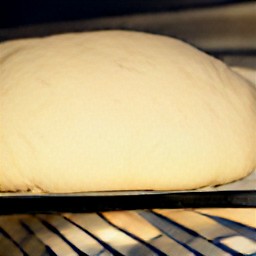 the surface of the bread dough has been cut by a knife.