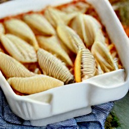 the baking dish is removed from the oven, the foil is removed, and it is placed back in the oven.