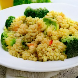 a plate of food consisting of tomatoes, bulgur, onions, garlic, and green bell pepper.
