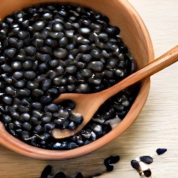 the black beans are transferred to a bowl.