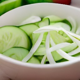 a bowl of cucumbers and onion slices in a sugar, vegetable oil, and white vinegar mixture.