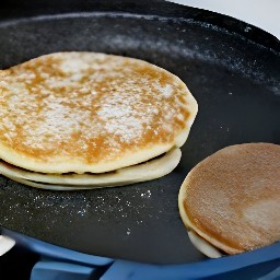 flipping the pancakes with a fish slice.