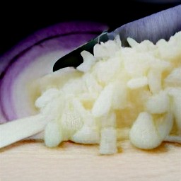 after peeling the onion and garlic, chop them into small pieces. then, chop the basil leaves into smaller pieces.