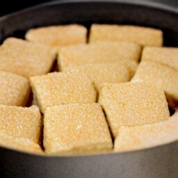 the coconut cake is cut into squares.