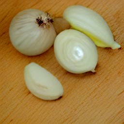 onions and garlic that are peeled and cut into slices.