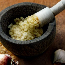 the garlic is crushed into a paste.