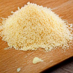 the parmesan cheese is grated into small pieces.