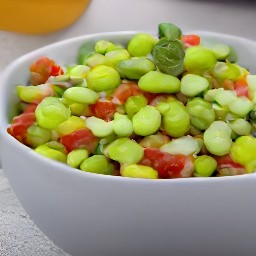 a bowl of edamame salad with lemon juice, yellow mustard, olive oil, salt, and black pepper.